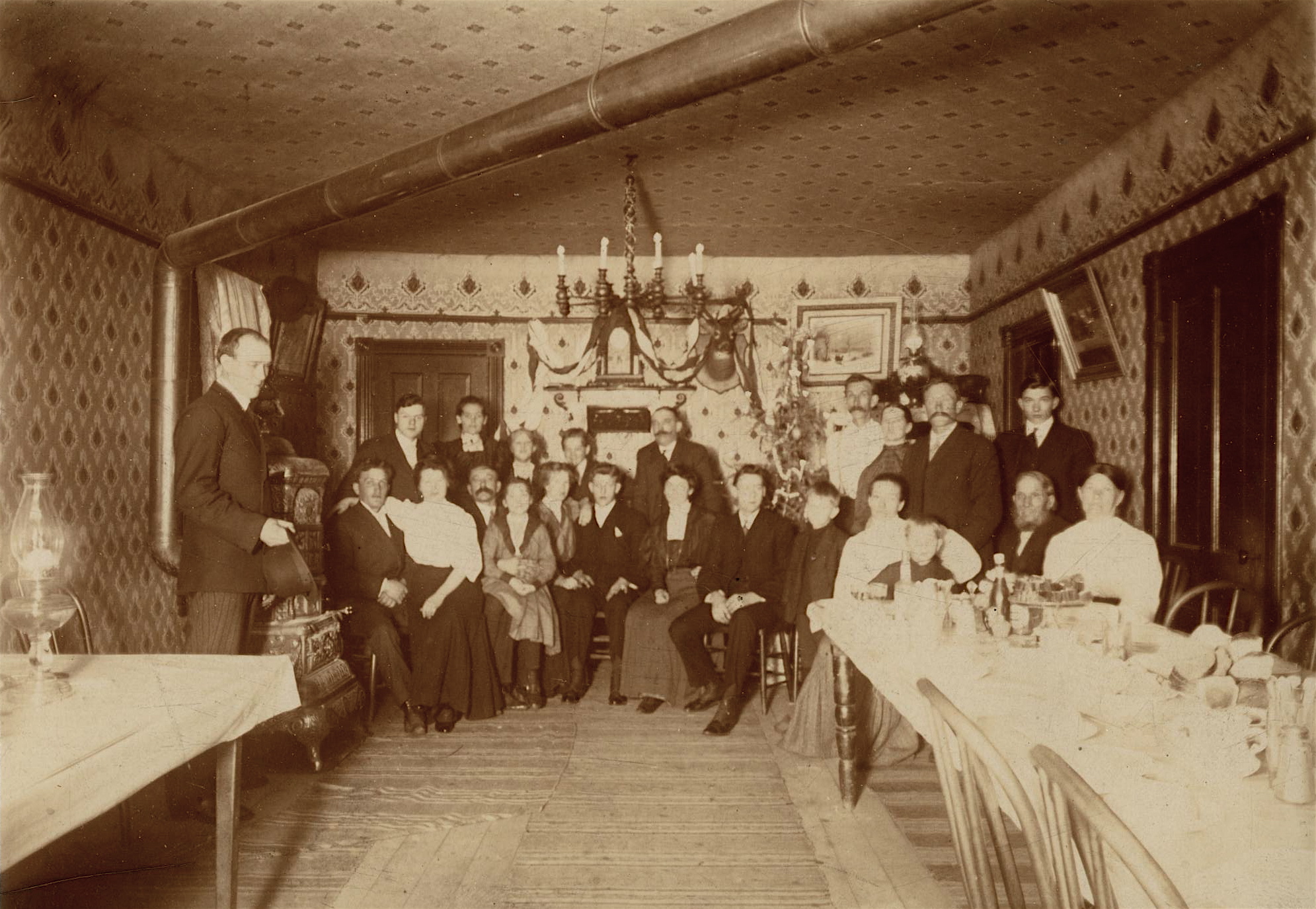 Men, Women, and children with Christmas decor in dining room
